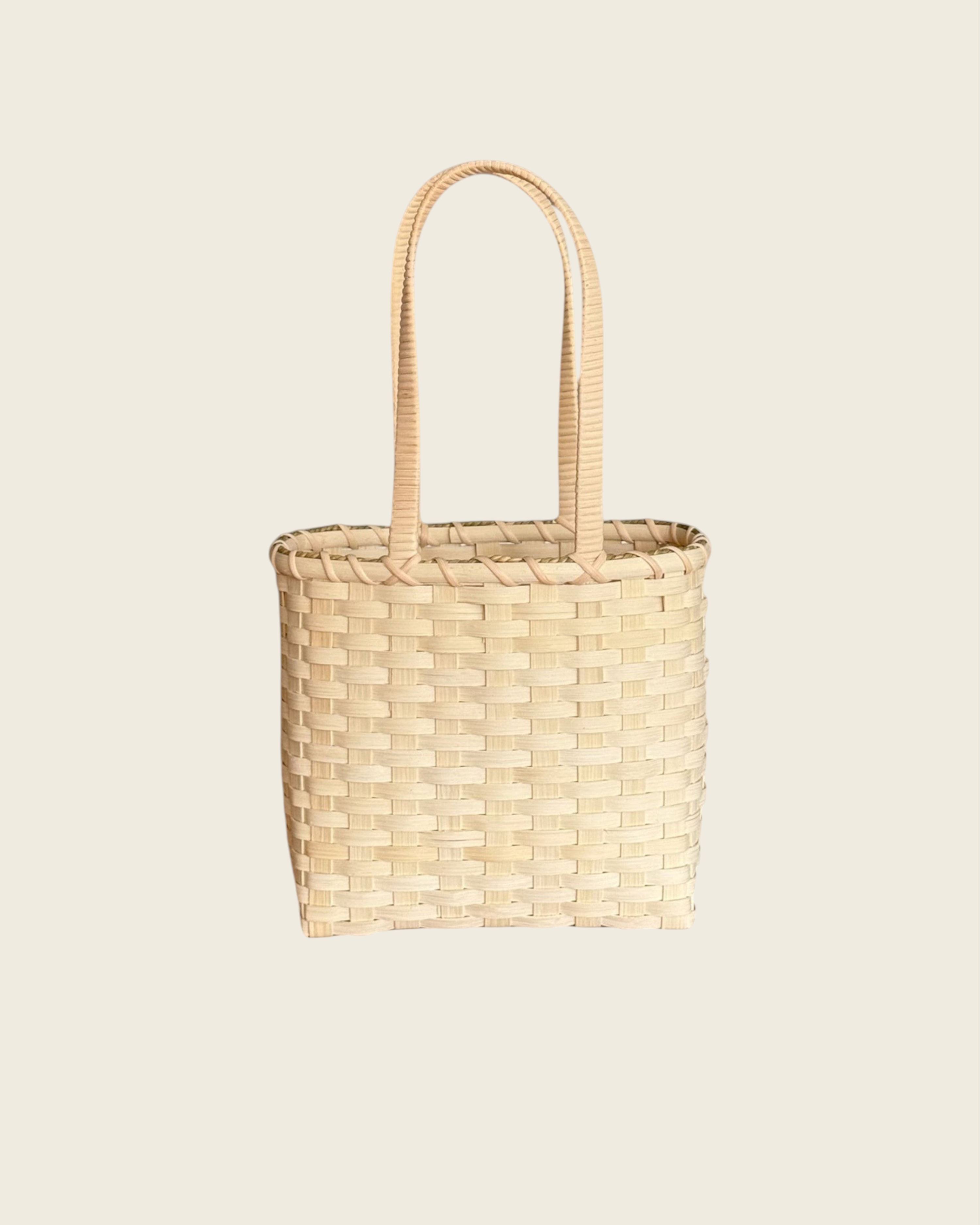 Weldun Carol lunch basket hand-woven from natural rattan with a structured rectangular shape and shoulder straps.