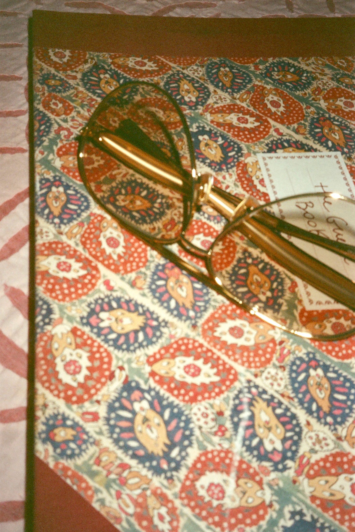 Aviator glasses resting on a paisley-patterned book